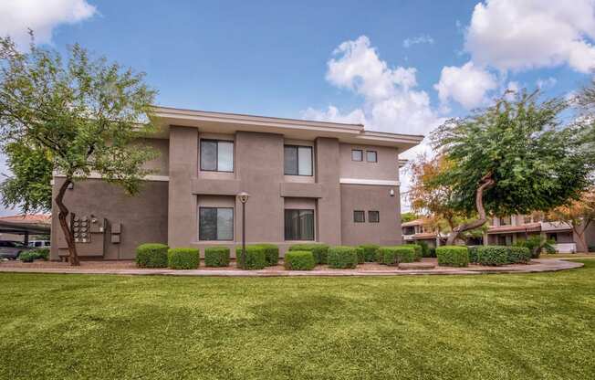 A modern house with a well-maintained lawn in front.