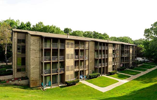 A long building with a green lawn in front.