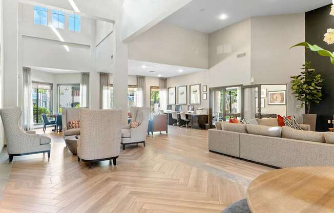 A spacious living room with a wooden floor and furniture.