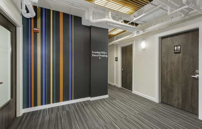Corridor with Wall Art with a white lettering on it at Sir Gallahad Apartment Homes, Bellevue, Washington 98004