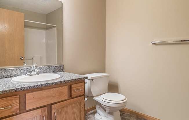 Tiled bathroom with lots of bright lighting at Skyline View Apartments in Lincoln NE