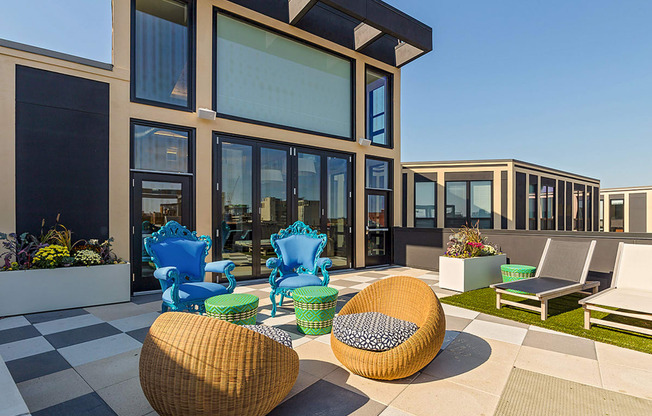 a patio with chairs and tables outside of a building at Ann Arbor City Club, Ann Arbor Michigan