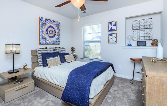 a bedroom with a bed and desk in a room