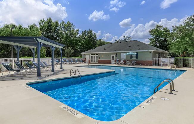 Swimming pool with covered deck seating at Ashley Oaks Apartments in Greensboro, North Carolina