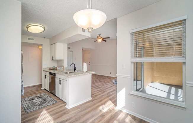 an open kitchen and living room with a large window