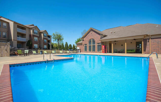 Swimming pool surrounded by club house and apartments