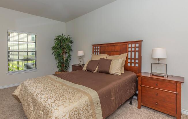 a bedroom with a bed and a chair in a room