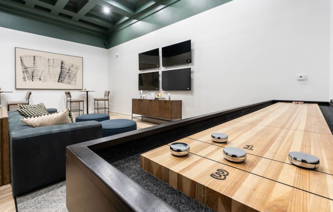 a squash court in a living room with a wooden table with balls on it