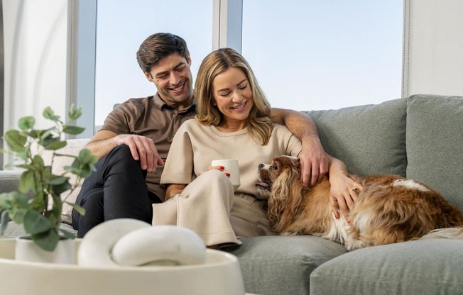 a man and woman sitting on a couch with a dog at AVE Phoenix Sky, Phoenix, AZ