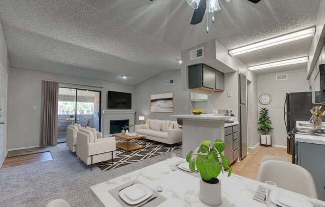 A modern living room with a dining area and kitchen in the background.