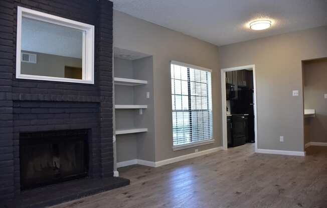 Oakwood Creek Apartments living area with fireplace and shelving