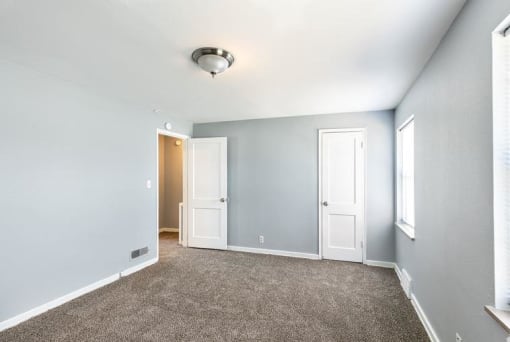 a empty room with blue walls and a carpet