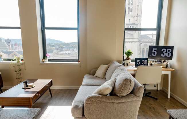 a living room with a couch and a table in front of a window