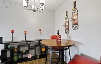 a dining area with a table and chairs and a chandelier