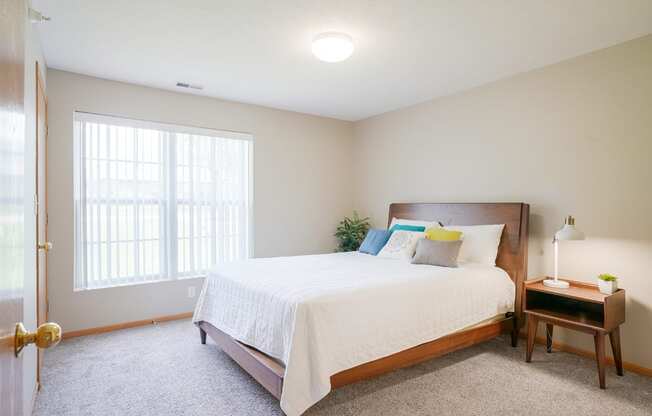 A furnished bedroom with a large bed and a window at Williamsburg Park