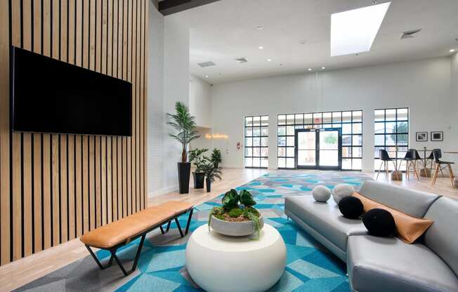 a clubhouse room with couches and a coffee table at Presidio Palms Apartments, Tucson, AZ