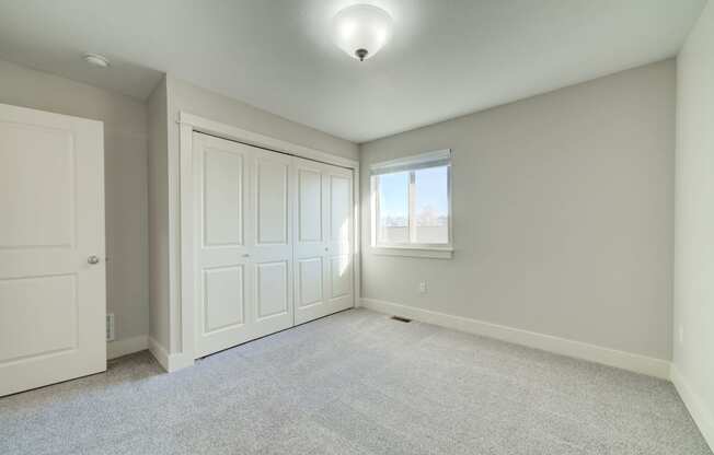 an empty room with two closets and a window at Copper Pines, Bozeman, MT, 59718