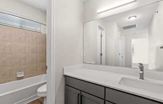 bathroom with sink and mirror at Switchback on Platte Apartments, Colorado, 80120