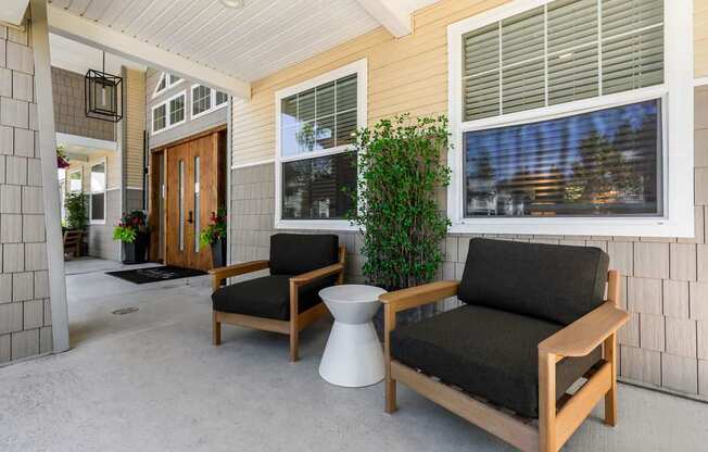 A patio with a chair and a table.