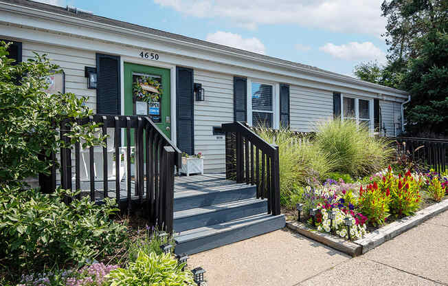 the exterior of rolling pines office with a garden in front of it