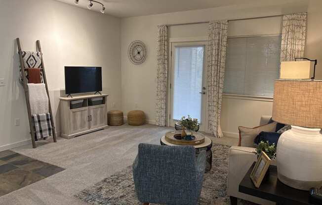 A living room with a blue chair and a television.
