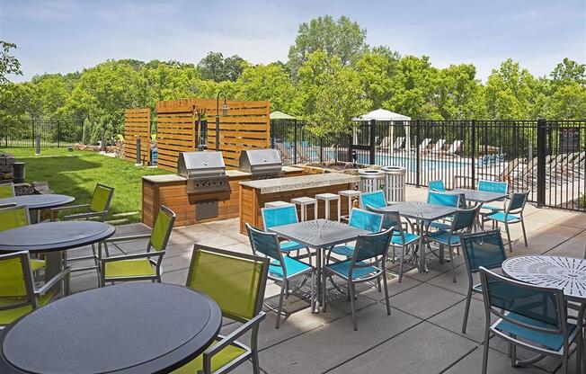 Be @ Axon Green  Outdoor Sitting Area with blue and green chairs and steel tables