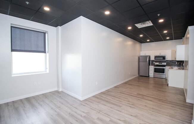 A kitchen area with a refrigerator, microwave, and oven.