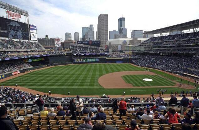 A baseball stadium is filled with fans watching a game.