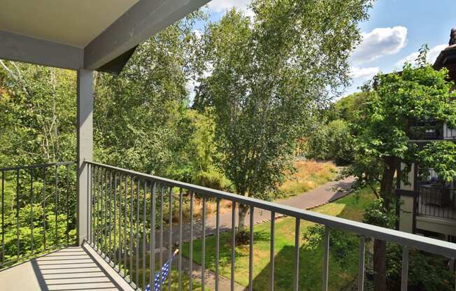 a balcony with a view of trees and a road