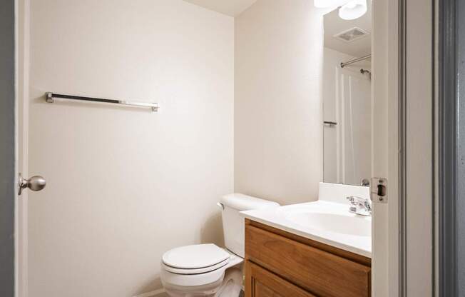 A white toilet sits next to a sink in a small bathroom.