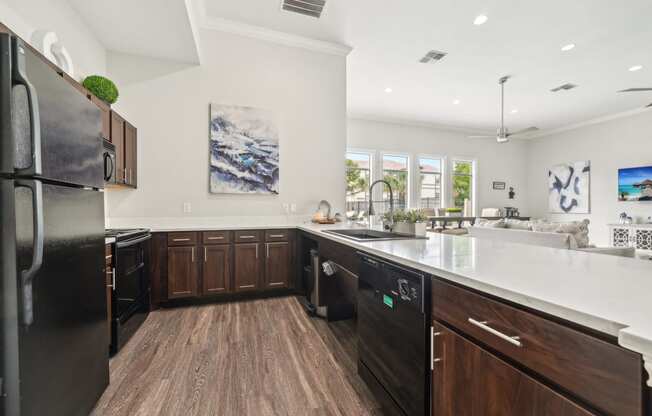 a large kitchen with wooden cabinets and a white counter top