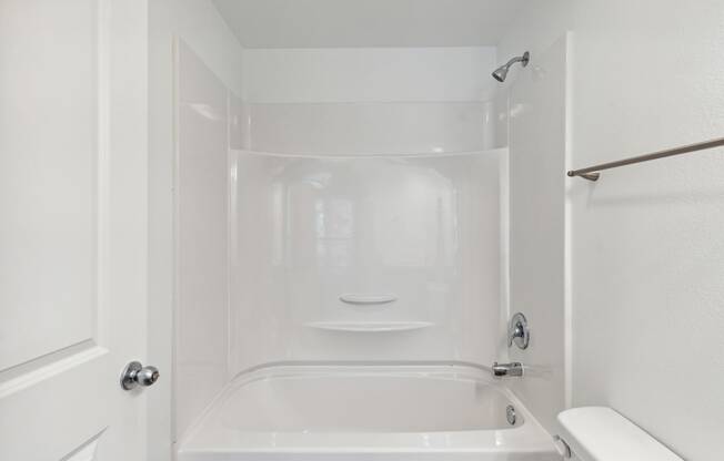 a bathroom with a shower and a sink and a bath tub