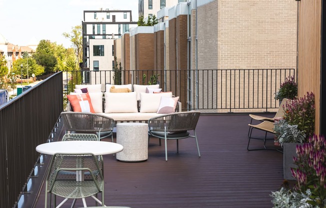 A patio with a white table and chairs.