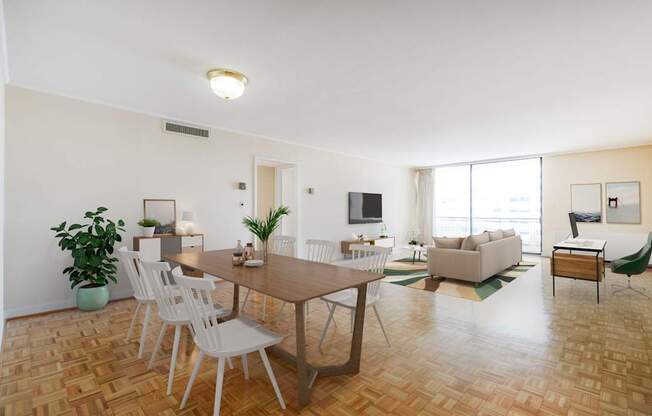 A living room with a brown table and white chairs.