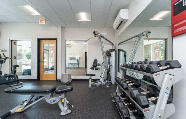 a gym with cardio equipment and weights at one mansfield ave