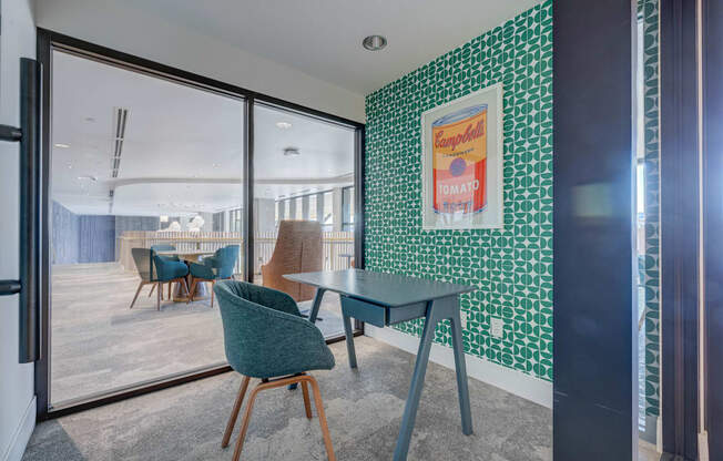 A room with a green chair and a green table.