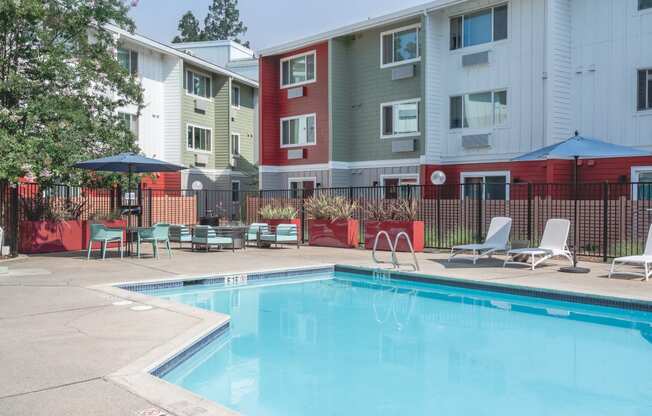 our apartments have a swimming pool with chairs and umbrellas