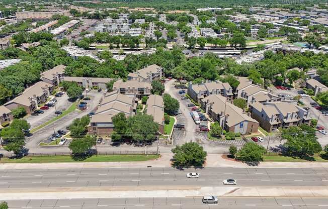 an aerial view of a suburban neighbourhood with cars parked on the street