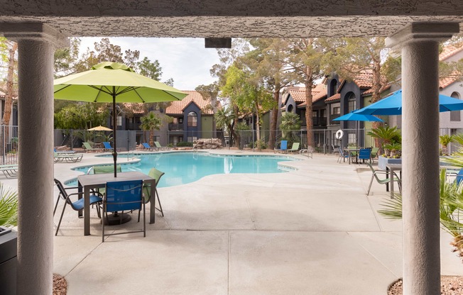 our apartments have a swimming pool with tables and umbrellas