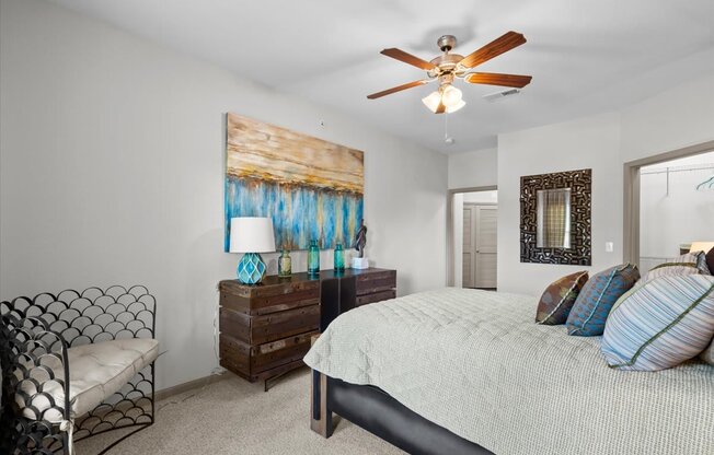 a bedroom with a bed and a ceiling fan