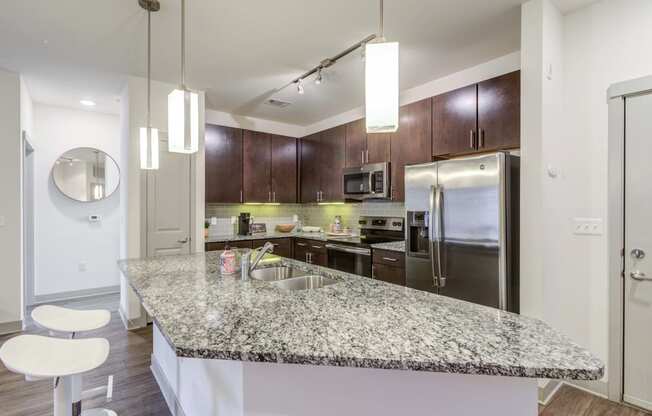 Carillon Apartments in Nashville, TN 37219 photo of a kitchen with granite counter tops and stainless steel appliances