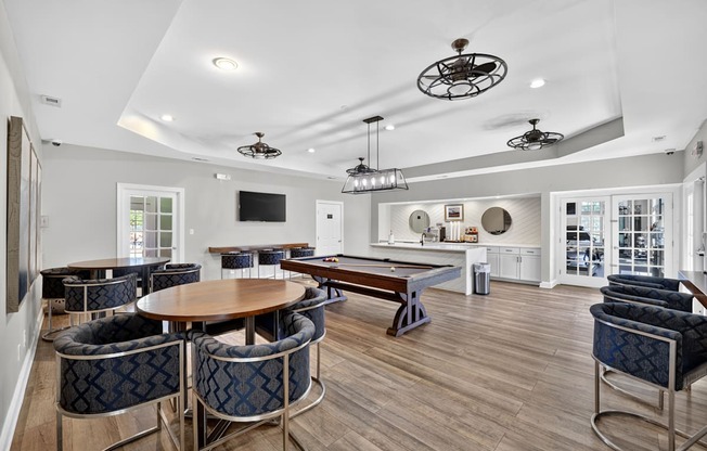 Community room with billiards table, seating with tables and community kitchen with coffee machine