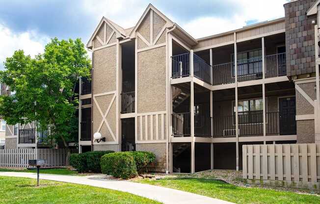 A large building with a balcony and a fence in front of it.