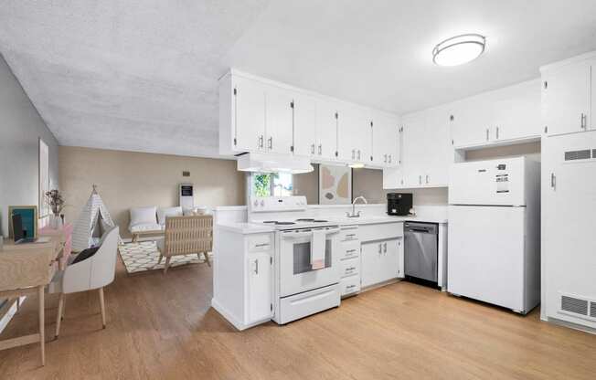 a kitchen with white cabinets and appliances and a dining table