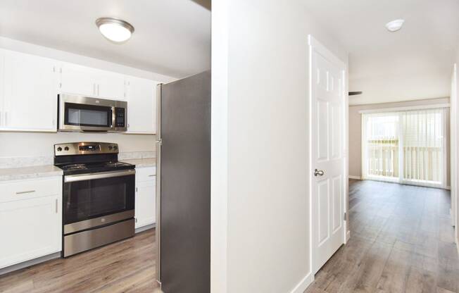 a renovated kitchen with white cabinets and a black stove