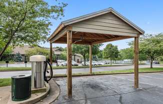 Covered car detailing station with vacuum and trash can