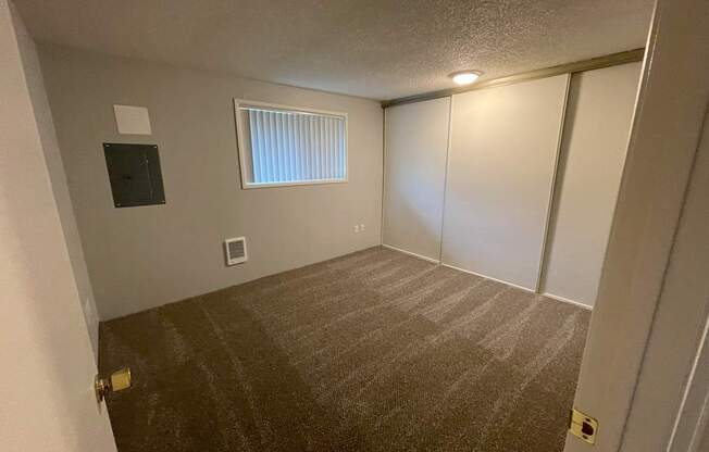 A room with a window and a door.