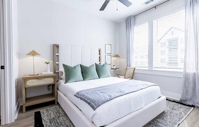 Large bedroom with oversized white trim and abundant natural light at Novel Cary