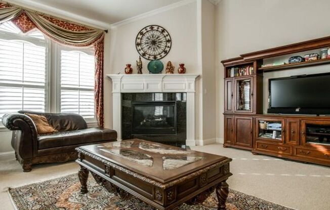 Bright and airy living room, fireplace, study, custom lighting in the formal living and dining.