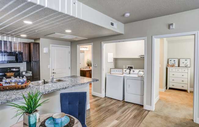 a kitchen and dining area in a 555 waverly unit at The Beckstead, South Jordan, Utah